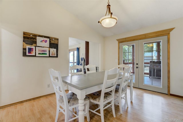 1011 S S, Woodland Park, CO 80863 - dining space featuring french doors, light wood finished floors, lofted ceiling, and baseboards