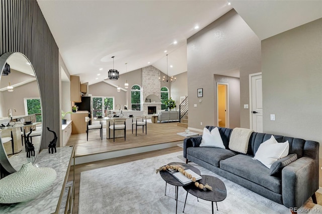 9371 Princeton Ln, Highlands Ranch, CO 80130 - living room with high vaulted ceiling, a chandelier, light wood finished floors, recessed lighting, and stairs