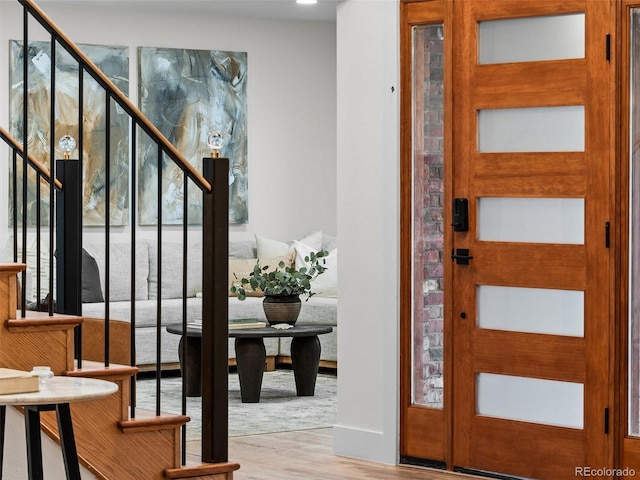 foyer featuring stairway and wood finished floors