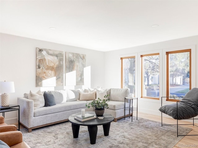 living area with light wood-style flooring and baseboards