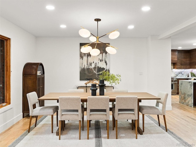 dining space featuring recessed lighting, an inviting chandelier, and light wood-style floors