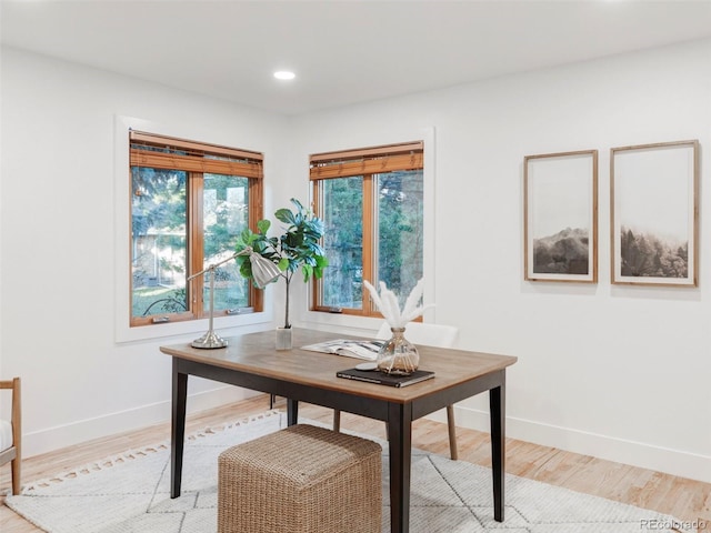 office space featuring recessed lighting, light wood-style flooring, and baseboards