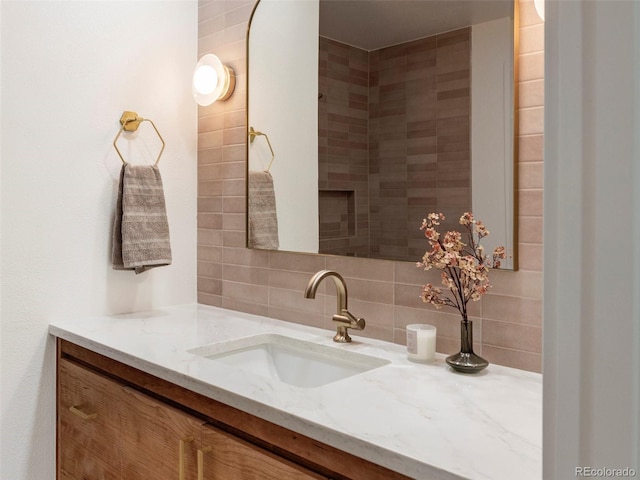 bathroom with vanity and decorative backsplash