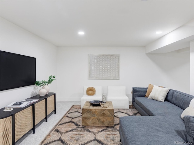 living area featuring recessed lighting, light colored carpet, and baseboards