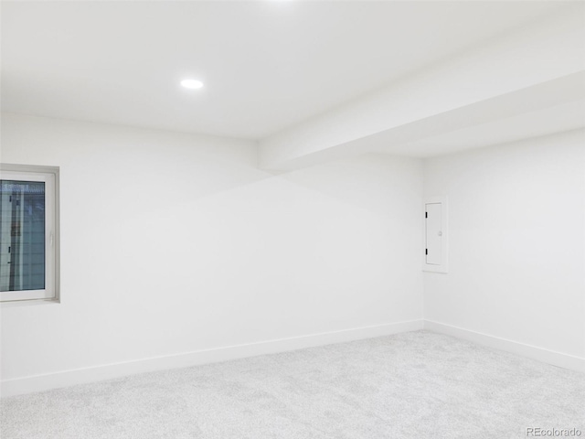 carpeted spare room featuring electric panel, baseboards, and recessed lighting