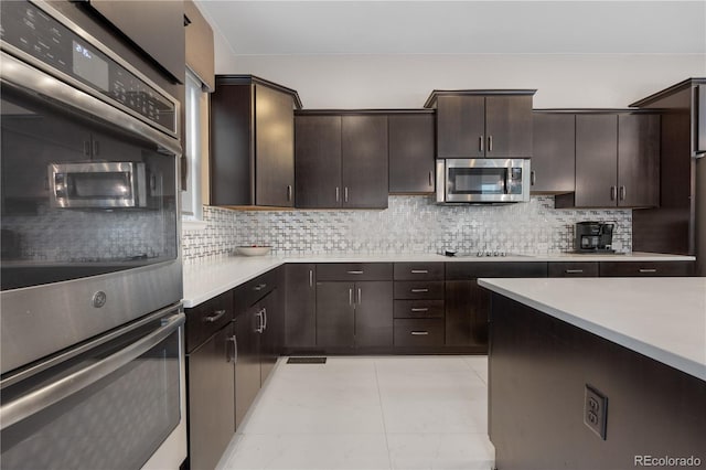 11193 Mission Walk St, Parker, CO 80134 - kitchen featuring appliances with stainless steel finishes, light countertops, decorative backsplash, dark brown cabinetry, and light tile patterned flooring