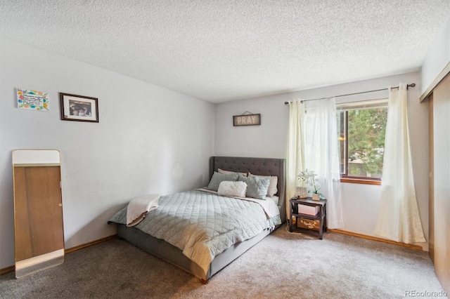 bedroom with carpet floors and a textured ceiling