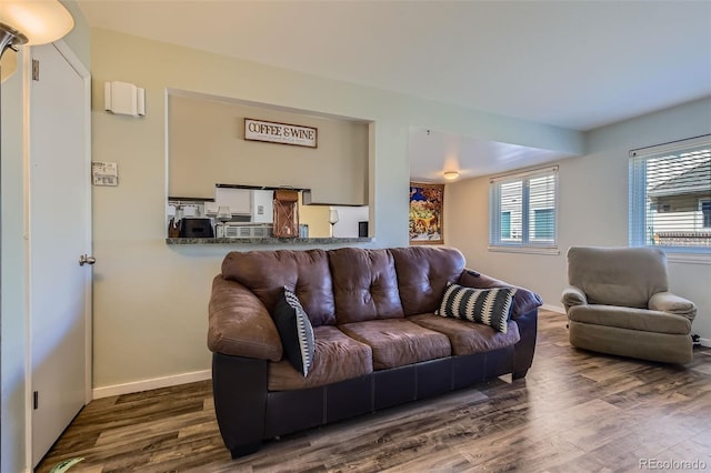 living area featuring dark wood finished floors and baseboards