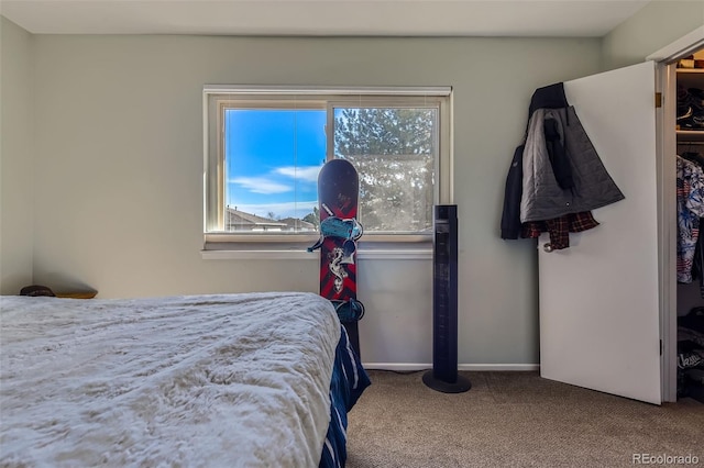 carpeted bedroom with baseboards