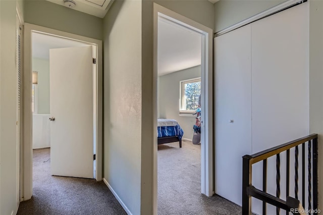 corridor featuring carpet floors and baseboards