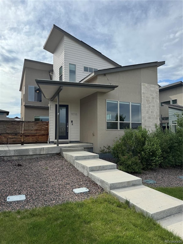 9715 Taylor River Cir, Littleton, CO 80125 - contemporary home with stucco siding and a porch