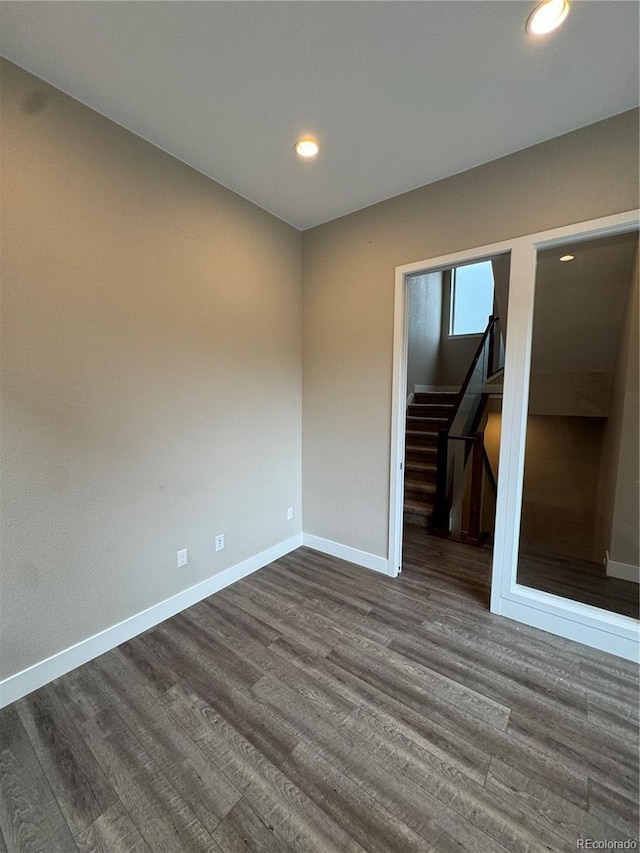 9715 Taylor River Cir, Littleton, CO 80125 - spare room with dark wood-style floors, recessed lighting, and stairs