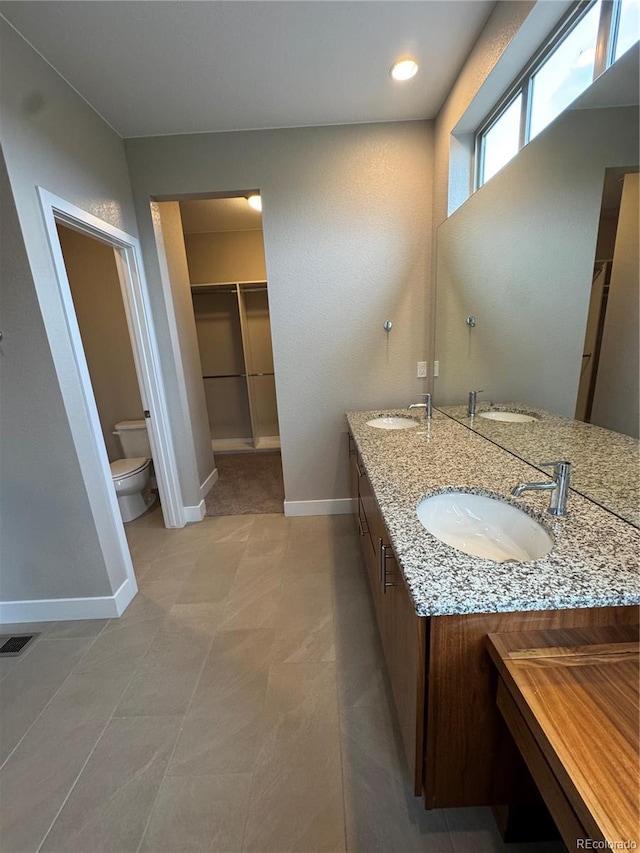 9715 Taylor River Cir, Littleton, CO 80125 - bathroom with double vanity and a walk in closet