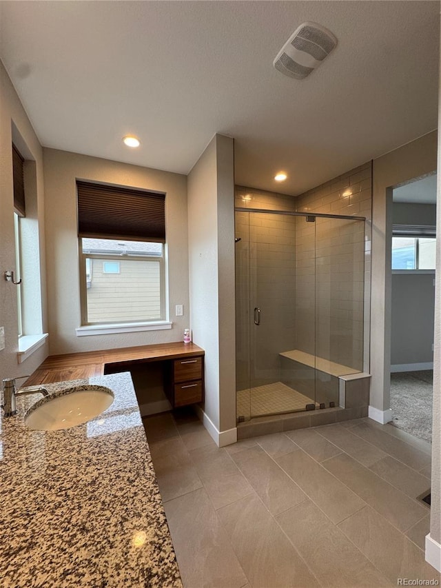 9715 Taylor River Cir, Littleton, CO 80125 - full bath featuring vanity, a stall shower, tile patterned flooring, and recessed lighting