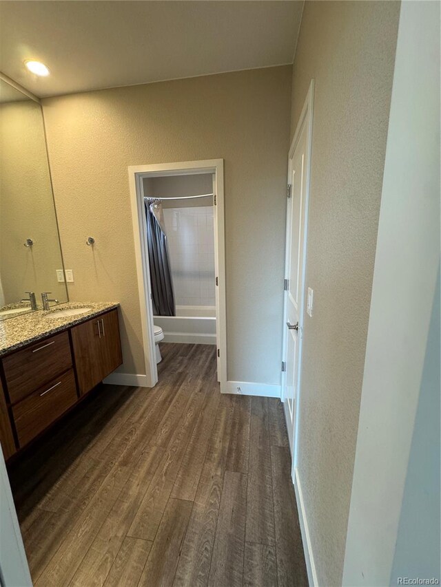 9715 Taylor River Cir, Littleton, CO 80125 - full bathroom with vanity, wood finished floors, shower / bath combo, and a textured wall