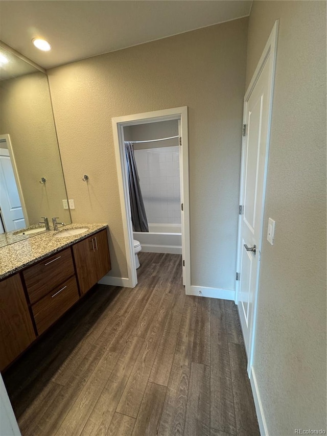 9715 Taylor River Cir, Littleton, CO 80125 - bathroom featuring vanity, wood finished floors, shower / bath combo, and a textured wall