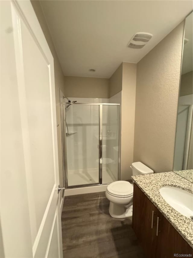 9715 Taylor River Cir, Littleton, CO 80125 - bathroom with vanity, wood finished floors, and a shower stall