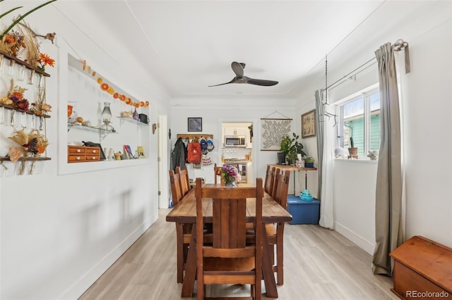 dining space with ceiling fan and light hardwood / wood-style floors