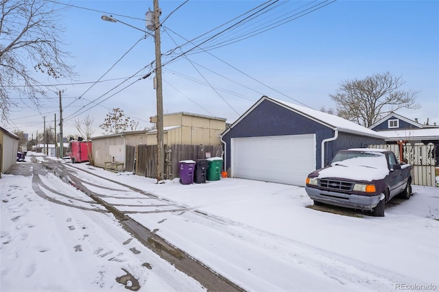 exterior space with a garage and an outbuilding