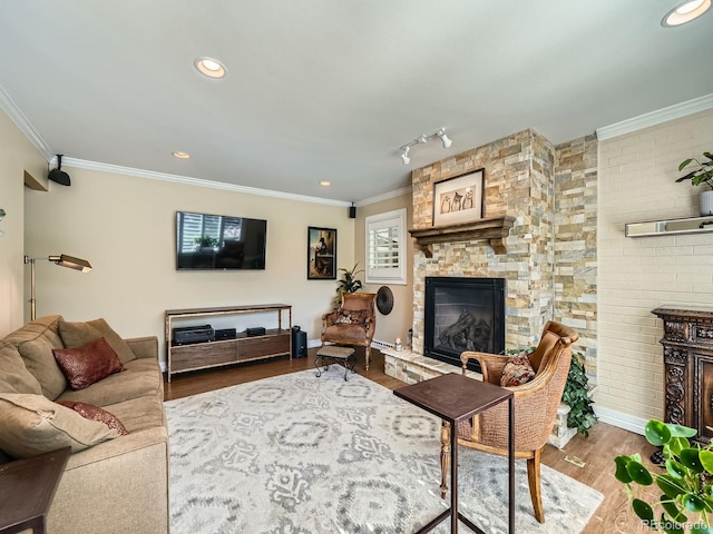 2609 S Dahlia St, Denver, CO 80222 - living area featuring a stone fireplace, wood finished floors, ornamental molding, baseboards, and recessed lighting