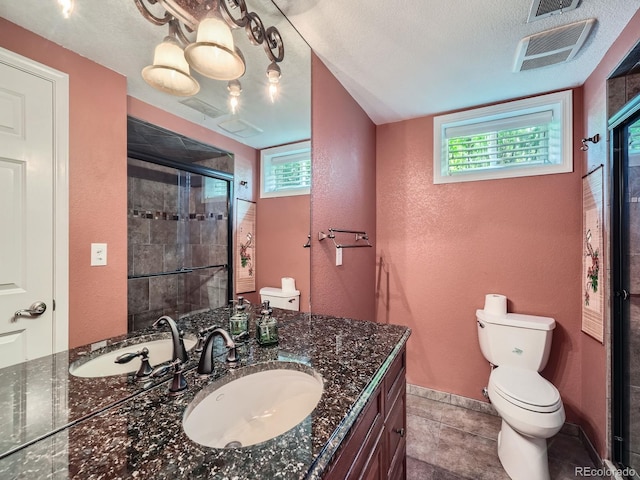 2609 S Dahlia St, Denver, CO 80222 - full bathroom featuring toilet, a textured wall, a stall shower, vanity, and plenty of natural light