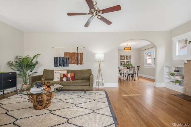 living room with light hardwood / wood-style floors and ceiling fan