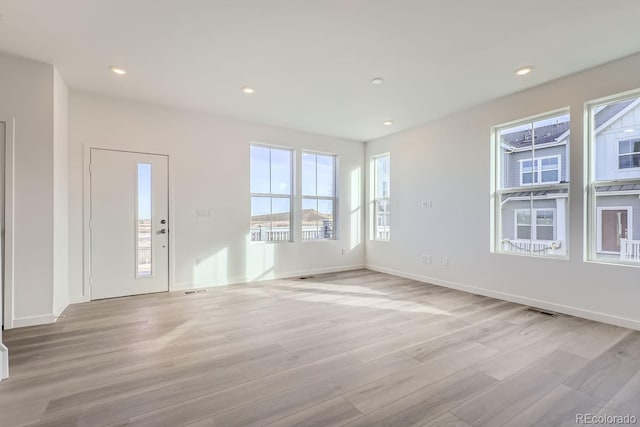 unfurnished room with light wood-type flooring