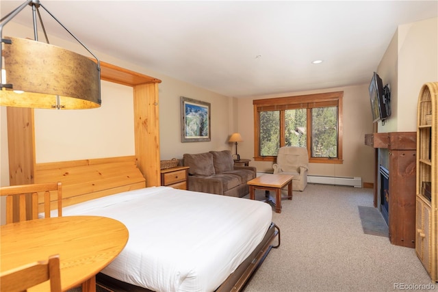 53 Hunki Dori Ct Unit 8886, Keystone, CO 80435 - bedroom with a baseboard radiator, a fireplace with flush hearth, light colored carpet, and recessed lighting