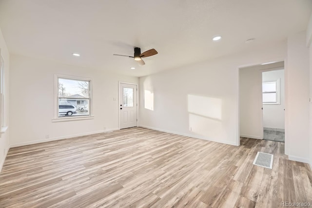 unfurnished living room featuring ceiling fan and light wood-type flooring