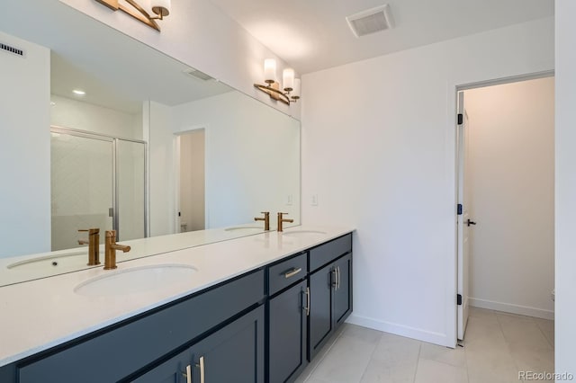 bathroom with vanity, tile patterned floors, and a shower with door