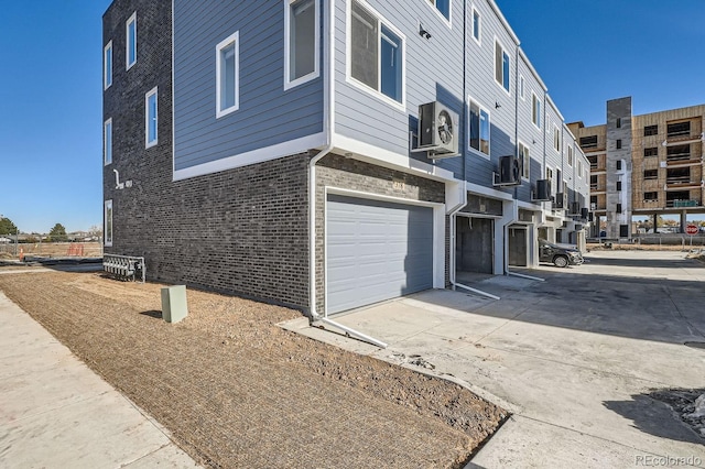 exterior space featuring a garage and cooling unit