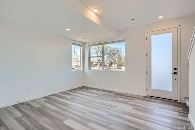 spare room with light hardwood / wood-style flooring