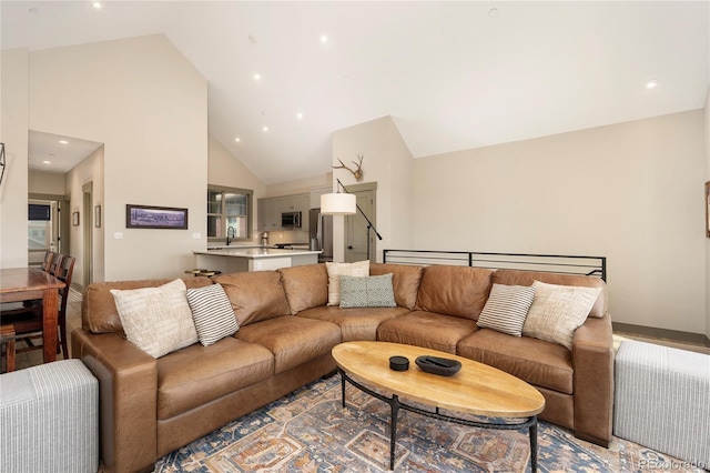 living room with high vaulted ceiling and recessed lighting