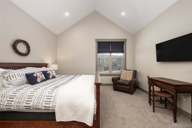 bedroom with vaulted ceiling, light colored carpet, and baseboards