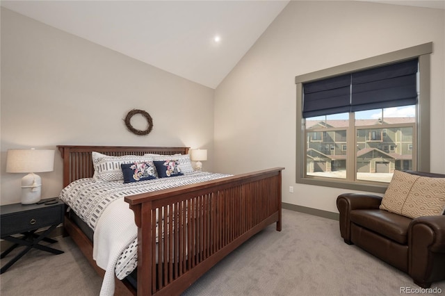 carpeted bedroom with baseboards and high vaulted ceiling