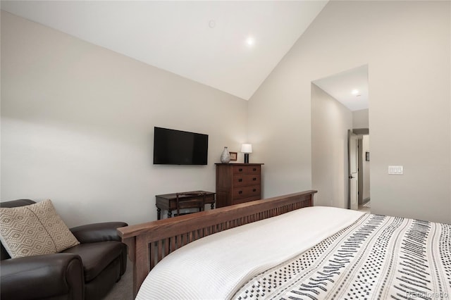 bedroom with high vaulted ceiling