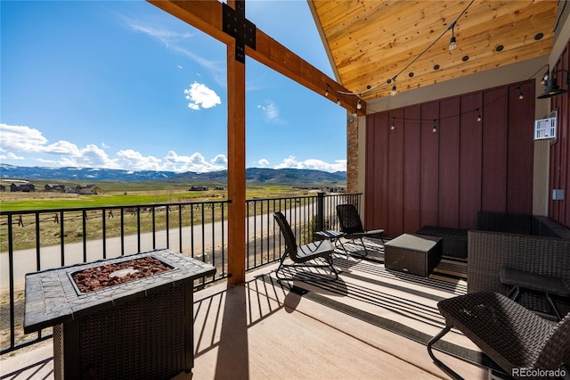 balcony with an outdoor fire pit and a mountain view