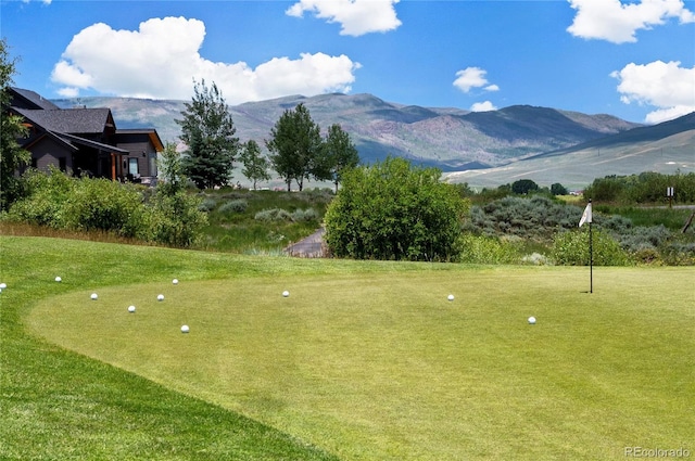 surrounding community featuring a mountain view and a yard
