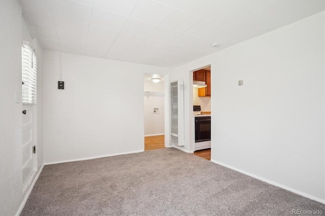 5549 S Greenwood St, Littleton, CO 80120 - empty room featuring light carpet, baseboards, and a heating unit