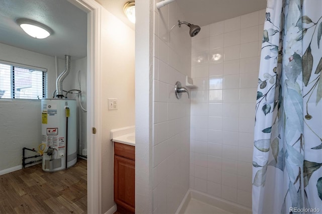 5549 S Greenwood St, Littleton, CO 80120 - full bath featuring gas water heater, wood finished floors, tiled shower, and vanity