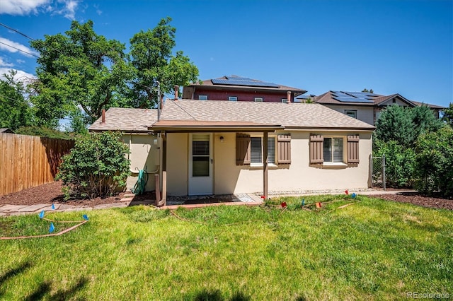 5549 S Greenwood St, Littleton, CO 80120 - back of property featuring roof mounted solar panels, stucco siding, and roof with shingles