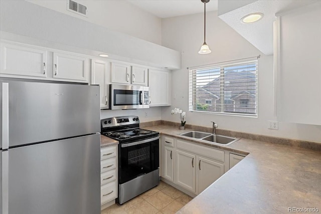 18661 E Water Dr Unit F, Aurora, CO 80013 - kitchen featuring stainless steel appliances, white cabinets, lofted ceiling, pendant lighting, and light tile patterned flooring