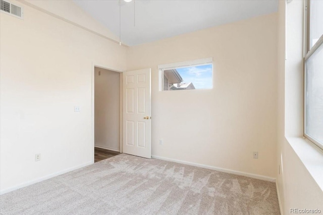 18661 E Water Dr Unit F, Aurora, CO 80013 - spare room featuring carpet floors and lofted ceiling