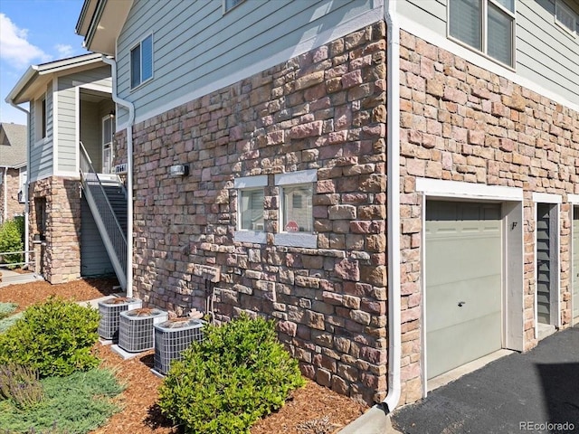 18661 E Water Dr Unit F, Aurora, CO 80013 - view of home's exterior featuring a garage and stone siding