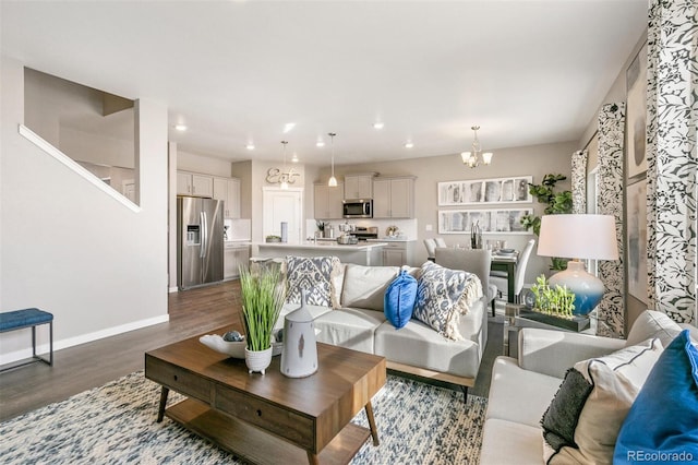 living room featuring hardwood / wood-style flooring and a notable chandelier