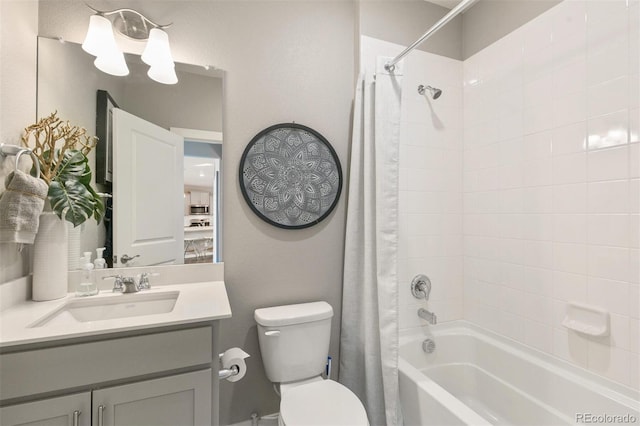 full bathroom with tiled shower / bath combo, vanity, and toilet