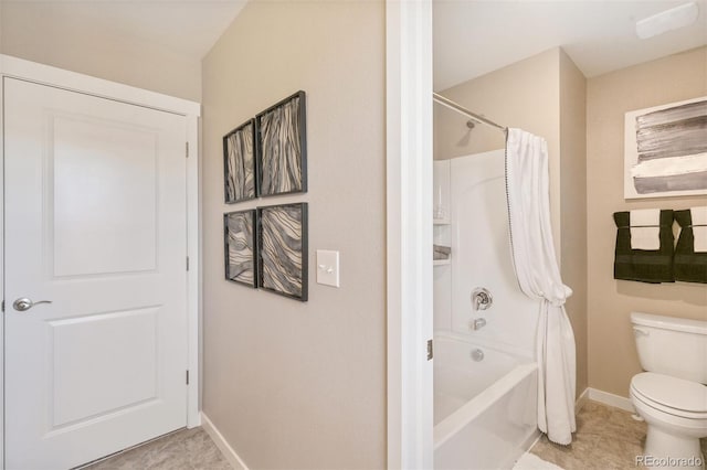 bathroom with tile patterned flooring, toilet, and shower / bath combo with shower curtain