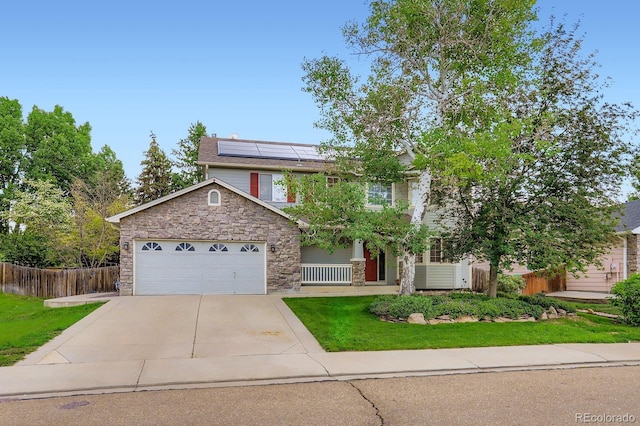 1616 Cedarwood Dr, Longmont, CO 80504 - view of front of home with stone siding, solar panels, driveway, and an attached garage