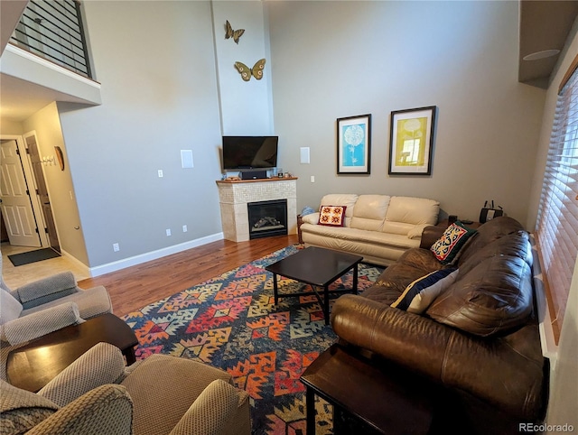 1616 Cedarwood Dr, Longmont, CO 80504 - living area with wood finished floors, a tiled fireplace, and a towering ceiling