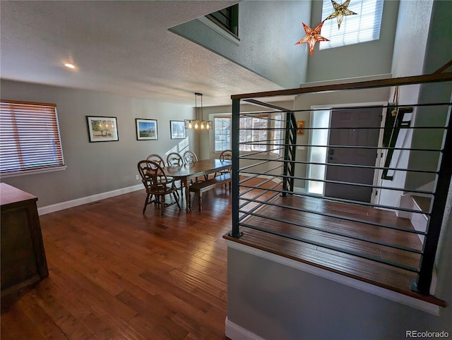 1616 Cedarwood Dr, Longmont, CO 80504 - staircase featuring a chandelier, wood finished floors, and healthy amount of natural light